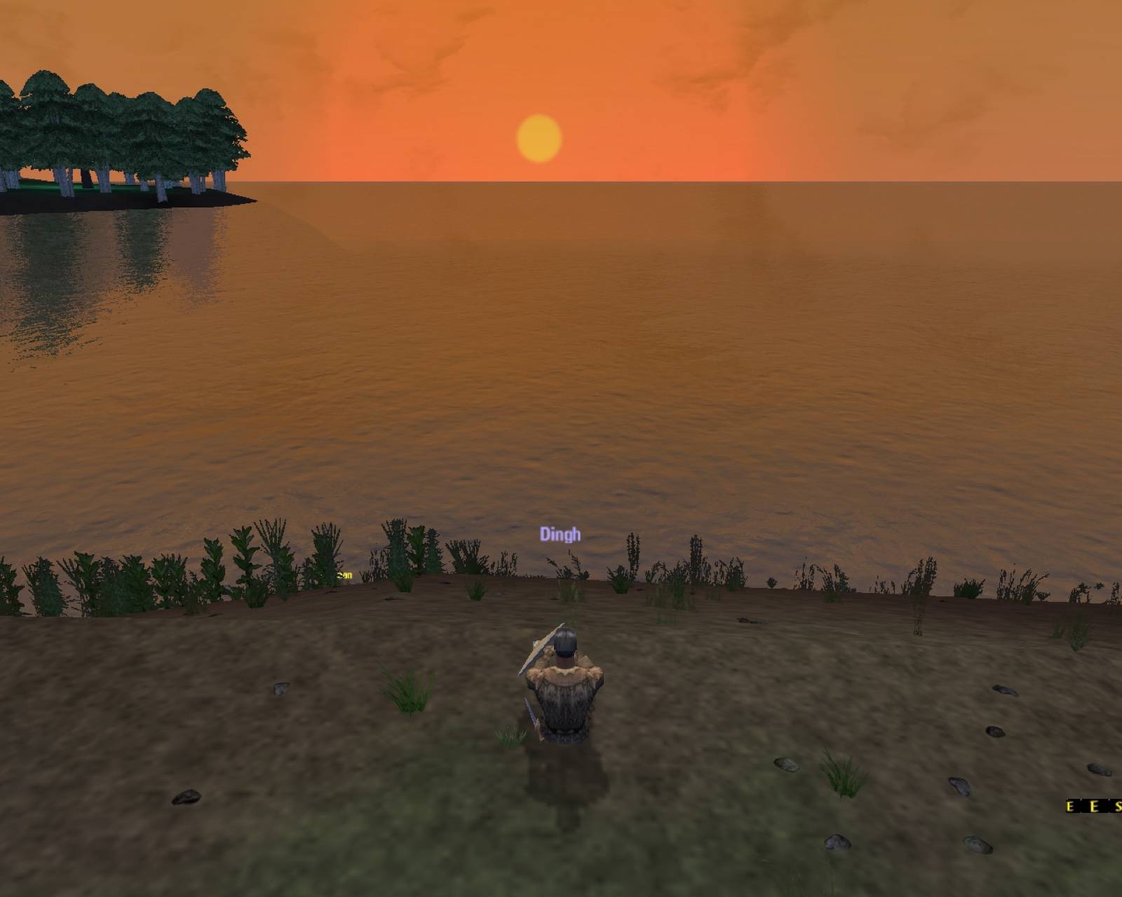 A small hooded figure sits alone on a muddy lakeshore, looking out at an enormous orange sunset.